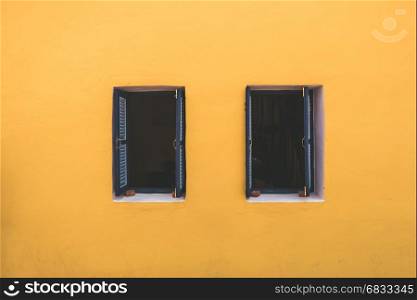 Vintage windows on the yellow wall