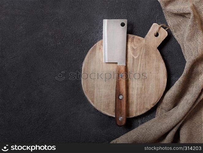 Vintage wooden cutting board with towel and meat hatchet. Kitchen cooking concept. Space for text
