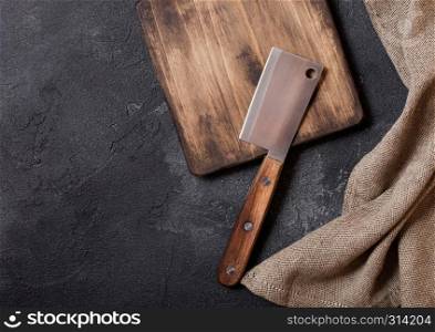 Vintage wooden cutting board with towel and meat hatchet. Kitchen cooking concept. Space for text