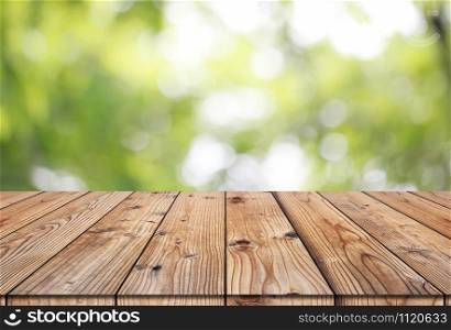 Vintage wooden pallet floor and blur nature background for design in your work backdrop concept.