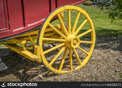 vintage wooden stagecoach wheel with a break