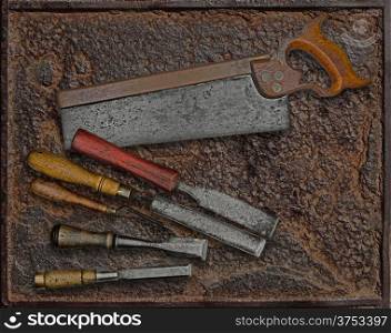 vintage woodworking tools over rusty industrial metal plate