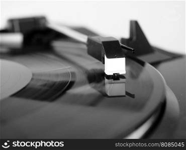 Vinyl record spinning. Vinyl record spinning on a turntable, focus on needle - in black and white