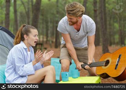 violent boyfriend hitting the table with guitar