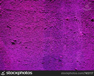 violet light illuminated concrete texture useful as a background. violet light concrete texture background