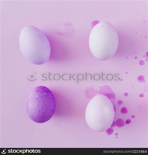 violet white easter eggs splashes dye liquid