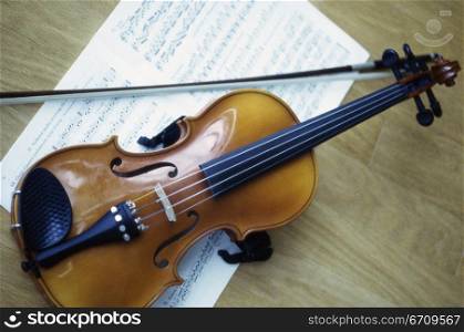 Violin and a bow on music sheets