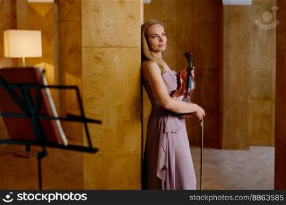 Violin in female hands. Elegant woman musician holding classic musical instrument. Violin in female hands cropped shot