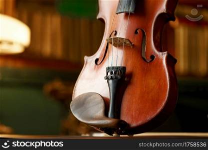 Violin in retro style, closeup view, nobody. Classical string musical instrument, music art, old brown viola, dark background. Violin in retro style, closeup view, nobody