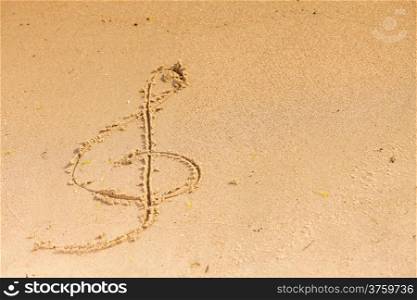 Violin key treble clef drawn in sand outdoor