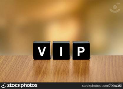 VIP or Very Important Person on black block with blurred background