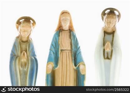 Virgin Mary statue with hands held out with angelic figures on each side against white background.