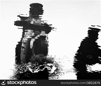 Virtual image, reflection silhouette of man riding motorbike on water, splash water