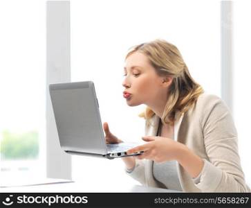 virtual relationships, online dating and social networking concept - woman sending kisses with laptop computer