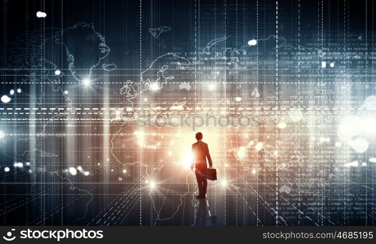 Virtual technologies. Back view of businessman with suitcase in hands looking at virtual panel