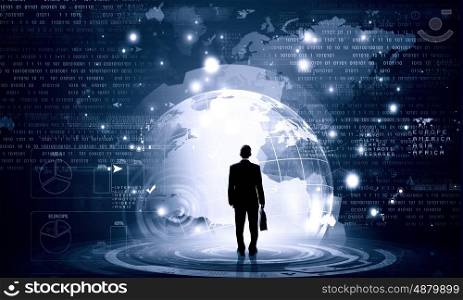 Virtual technologies. Back view of businessman with suitcase in hands looking at virtual panel