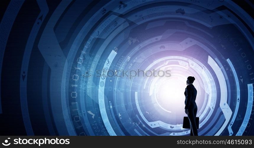 Virtual technologies. Back view of businesswoman with suitcase in hands looking at virtual panel