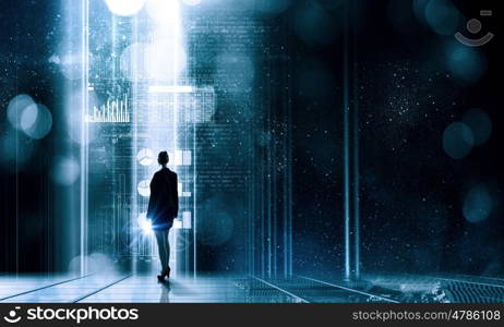 Virtual technologies. Back view of businesswoman with suitcase in hands looking at virtual panel