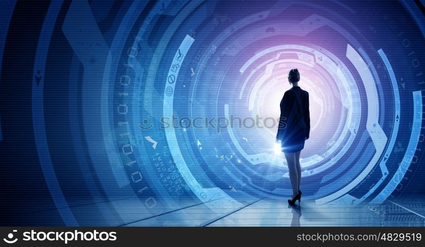 Virtual technologies. Back view of businesswoman with suitcase in hands looking at virtual panel