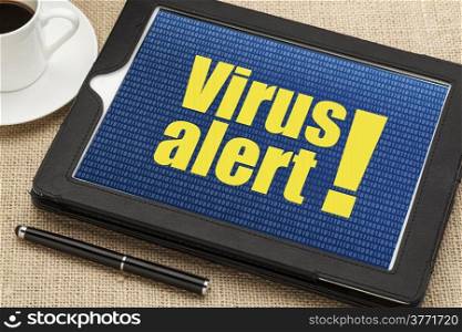 virus alert on a diigital tablet with a cup of coffee