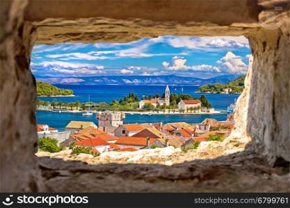 Vis island bay waterfront view through stone window, Dalmatia, Croatia
