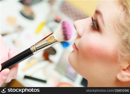Visage concept. Close up woman getting make up on cheeks. Applying blush with brush.. Close up woman getting make up, blush