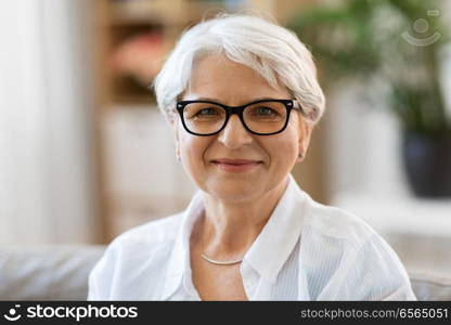 vision, age and people concept - portrait of happy senior woman in glasses. portrait of happy senior woman in glasses