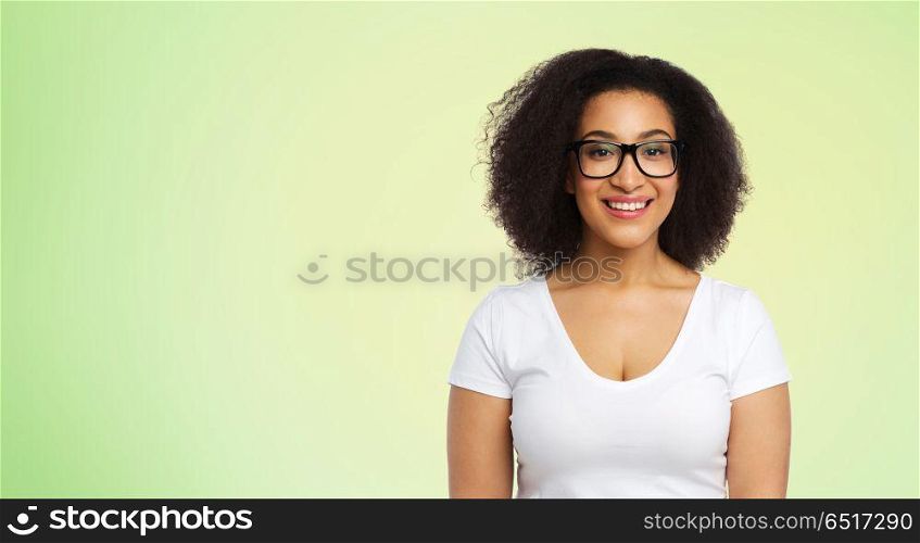 vision, body positive and people concept - happy african american woman in white t-shirt and glasses over lime green background. african american woman in glasses and t-shirt. african american woman in glasses and t-shirt