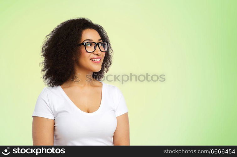 vision, body positive and people concept - happy african american woman in white t-shirt and glasses over lime green background. african american woman in glasses and t-shirt. african american woman in glasses and t-shirt