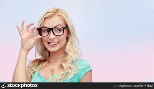 vision, education and people concept - happy smiling young woman or teenage girl glasses over pink background