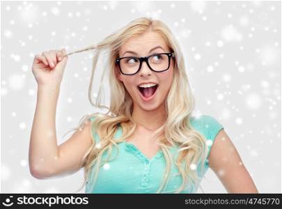 vision, education and people concept - happy smiling young woman or teenage girl glasses over snow