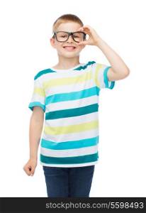 vision, education and school concept - smiling little boy in eyeglasses over white background