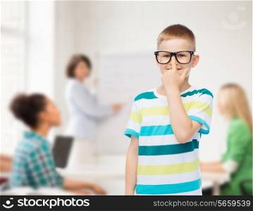 vision, education and school concept - smiling little boy in eyeglasses over white background