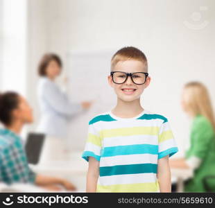 vision, education and school concept - smiling little boy in eyeglasses over white background