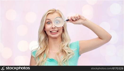 vision, exploration, investigation, education and people concept - happy smiling young woman or teenage girl looking through magnifying glass over pink holidays lights background