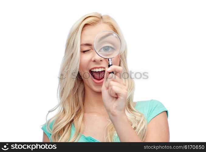 vision, exploration, investigation, education and people concept - happy smiling young woman or teenage girl looking through magnifying glass