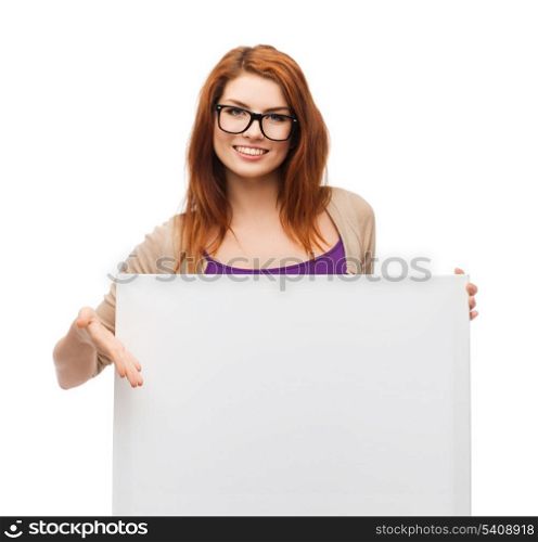 vision, health, advertisement and people concept - smiling girl wearing eyeglasses pointing finger to white blank board