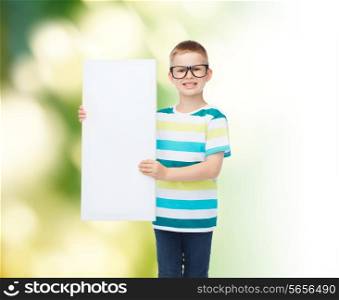 vision, health, advertisement, ecology and people concept - smiling little boy wearing eyeglasses with white blank board over green background