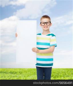 vision, health, advertisement, nature and people concept - smiling little boy wearing eyeglasses with white blank board over natural background