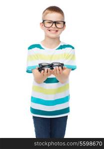 vision, health and people concept - smiling little boy in eyeglasses holding spectacles