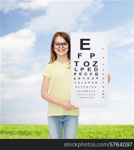 vision, health and people concept - smiling little girl wearing eyeglasses with eye checking chart