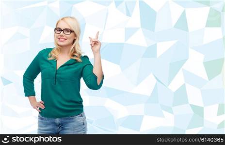 vision, optics, education, gesture and people concept - smiling young woman with eyeglasses pointing finger up over blue background