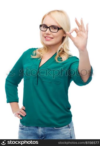 vision, optics, education, gesture and people concept - smiling young woman with eyeglasses showing ok