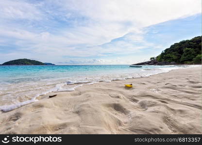 Visitors footprints on sand at beach near the sea during morning high tide remove traces of the chaos return to peaceful in Koh Miang island, Mu Ko Similan National Park, Phang Nga, Thailand