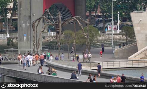 Visitors view the Maman sculpture by the Guggenheim Bilbao