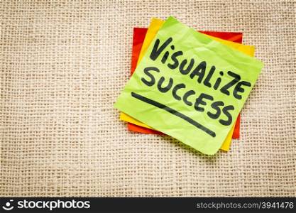 visualize success advice - handwriting on a sticky note against burlap canvas
