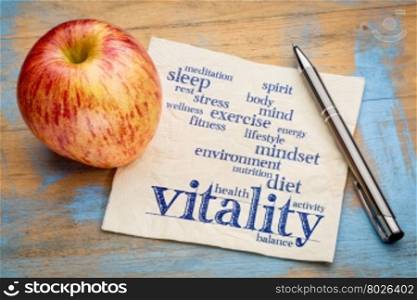 vitality and vital energy word cloud - handwriting on a napkin with a fresh apple