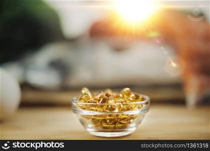 Vitamin D Supplements. Gel Capsules in Focus, Natural Sources of Vitamin D In Background. . Vitamin D Gel Capsules and Natural Sources of Vitamin D