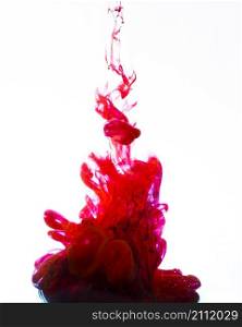 vivid red ink swirling underwater