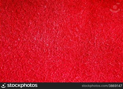 Vivid red natural leather texture closeup background, skin design abstract pattern.